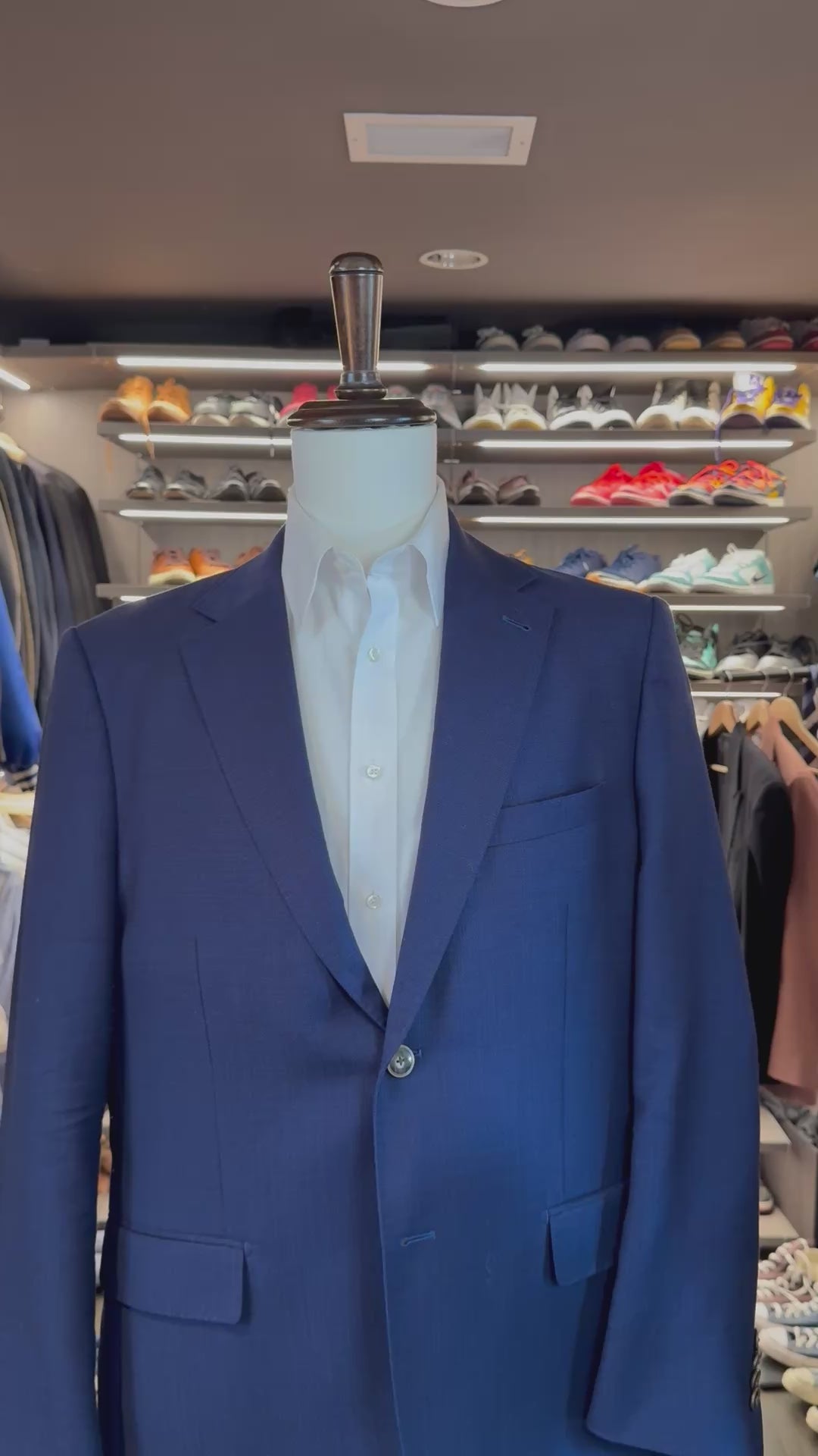 White Muse silk pocket square sliding into suit pocket — no folding required, permanently sewn signature fold by Stacy Claude Design