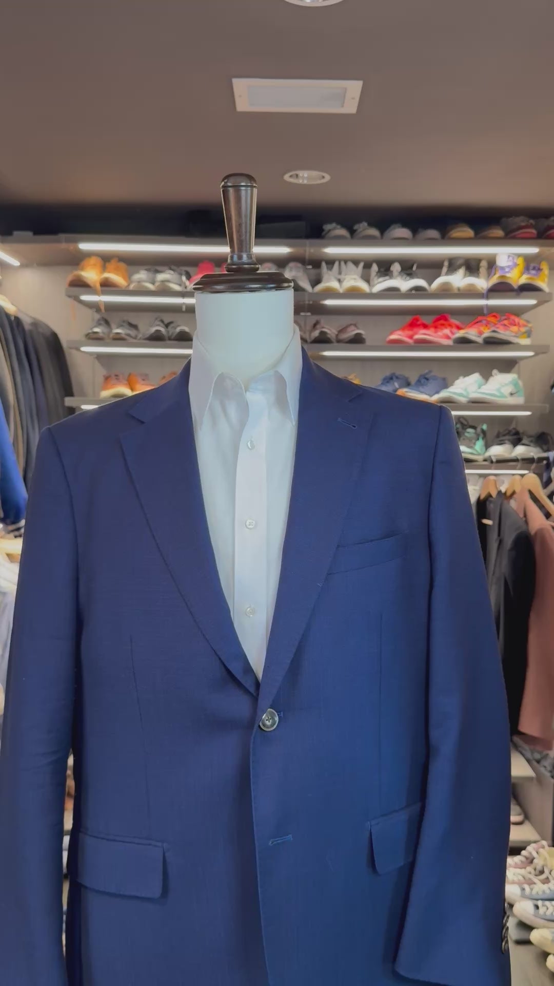 Blue and steel polka dot Cloud 9 silk pocket square sliding into suit pocket — no folding required, permanently sewn puff fold by Stacy Claude Design