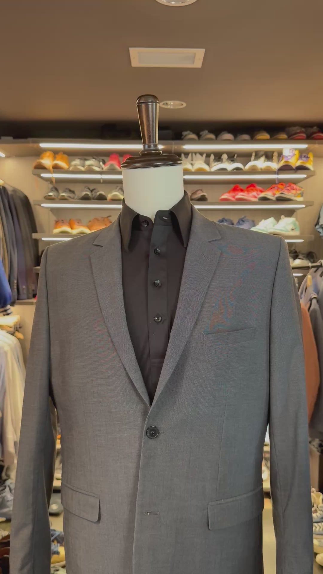 Black Dash silk pocket square sliding into suit pocket — no folding required, permanently sewn signature fold by Stacy Claude Design