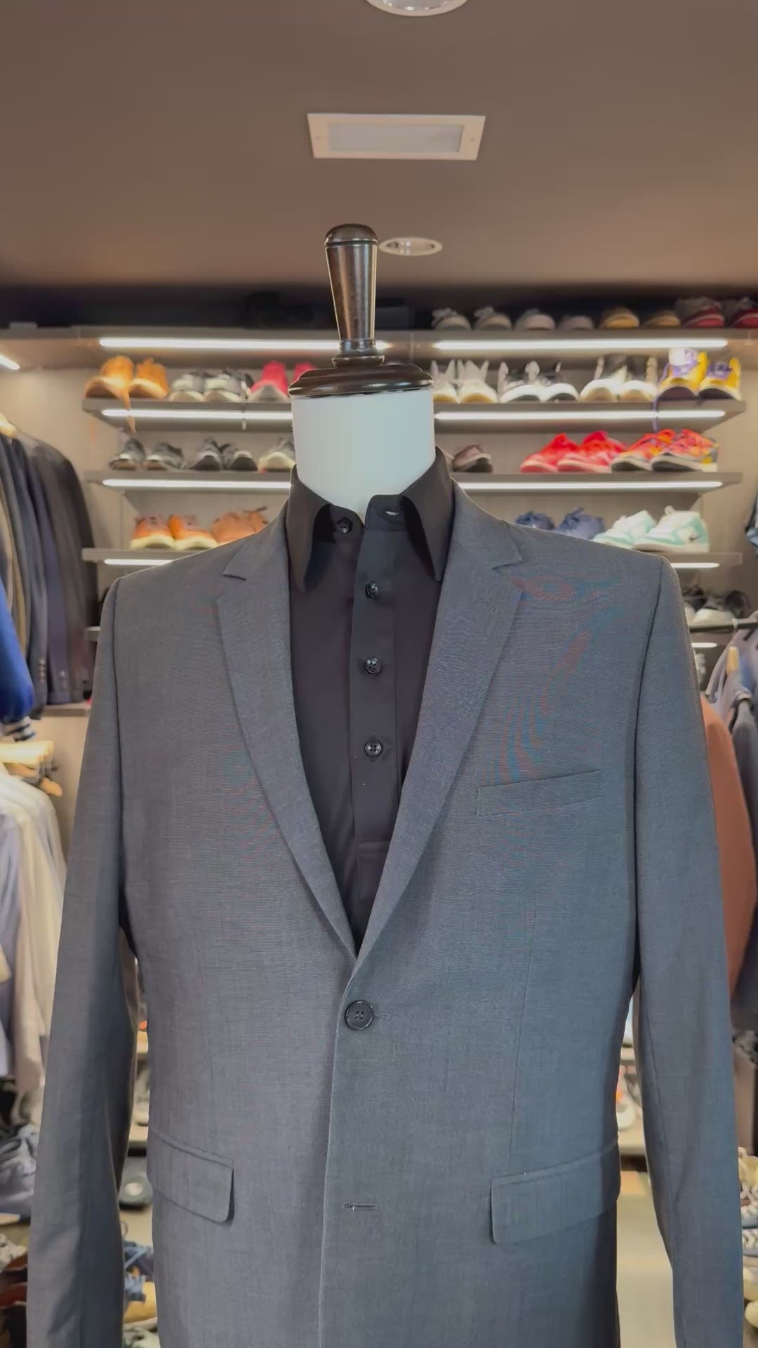 Black Cloud 9 silk pocket square sliding into suit pocket — no folding required, permanently sewn puff fold by Stacy Claude Design