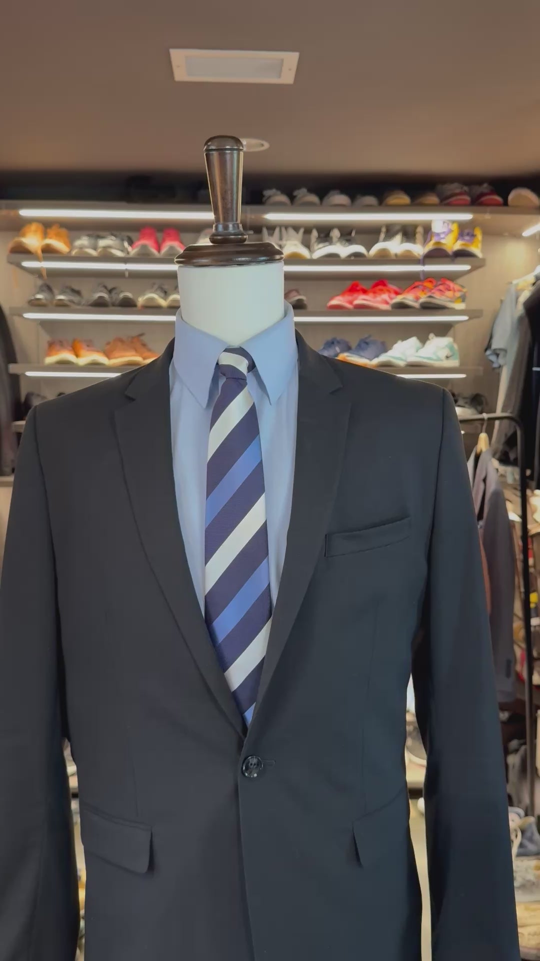 Blue Legacy silk pocket square sliding into suit pocket — no folding required, permanently sewn presidential fold by Stacy Claude Design